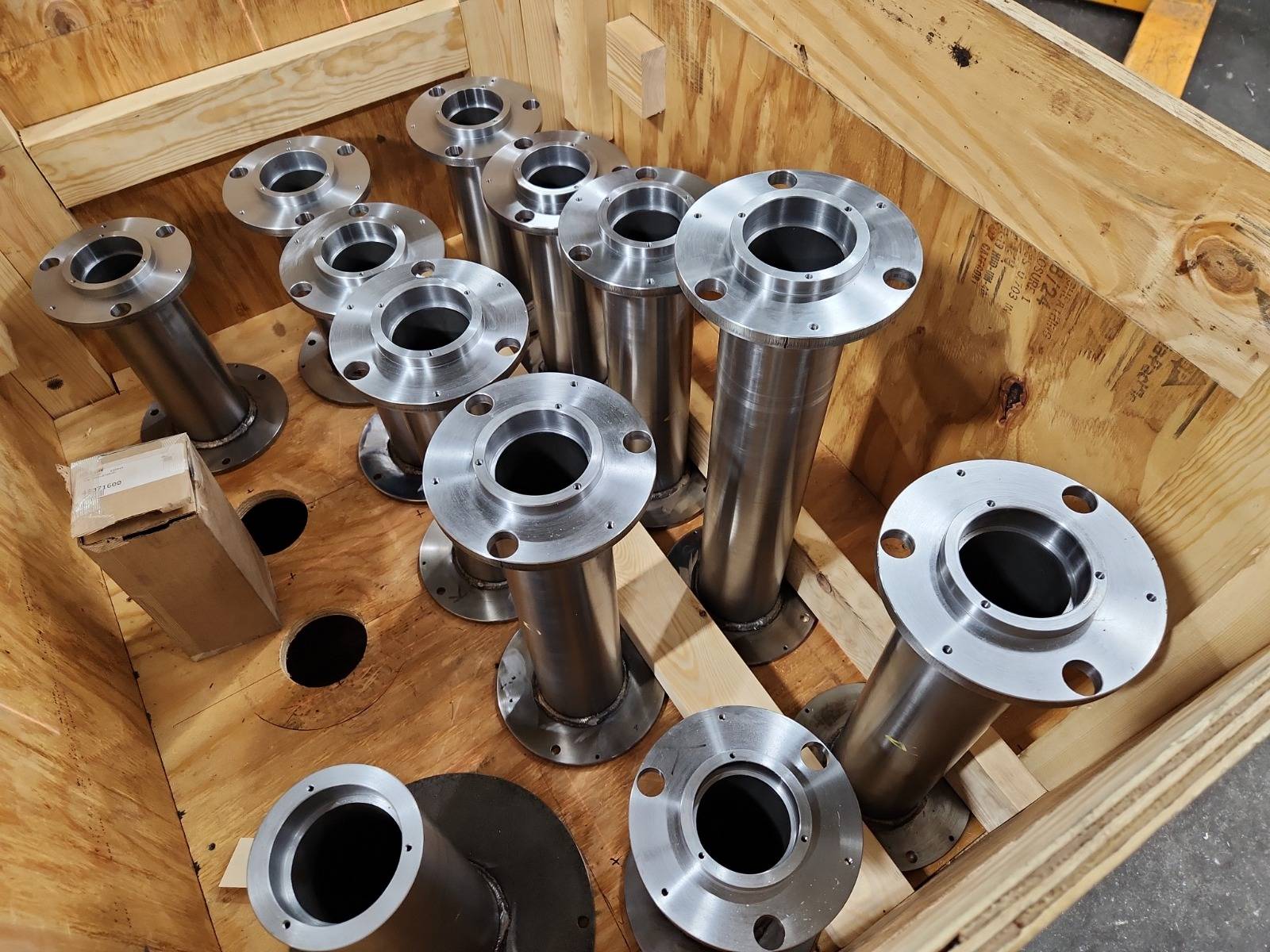 Flanged steel shafts packed in a wooden crate