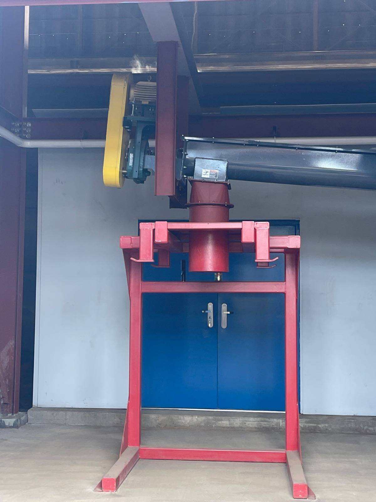 Red fabricated stand supporting a motor and drive assembly