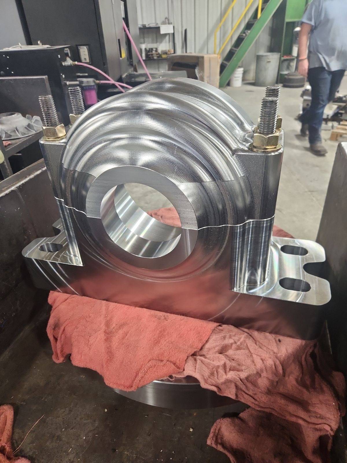 Large bored steel housing sitting in the machine shop